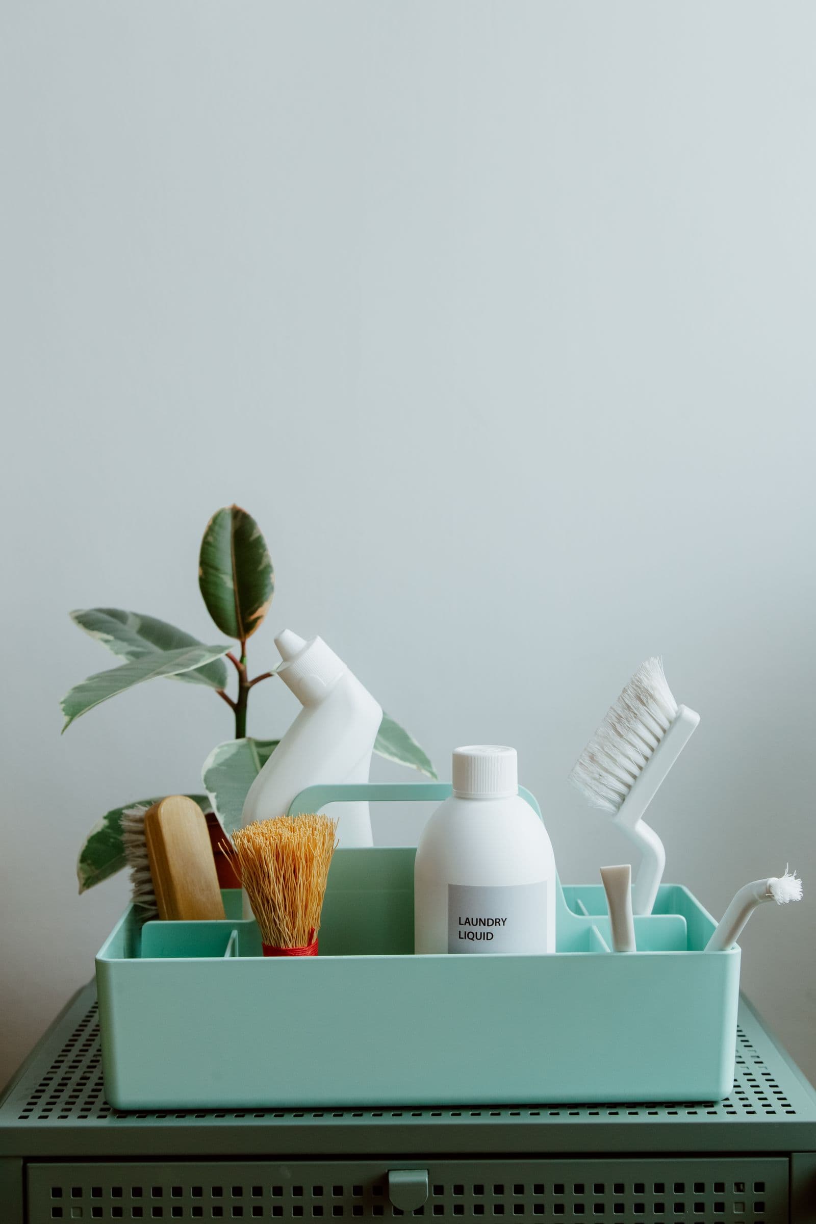 Eco-friendly cleaning products in a pastel caddy