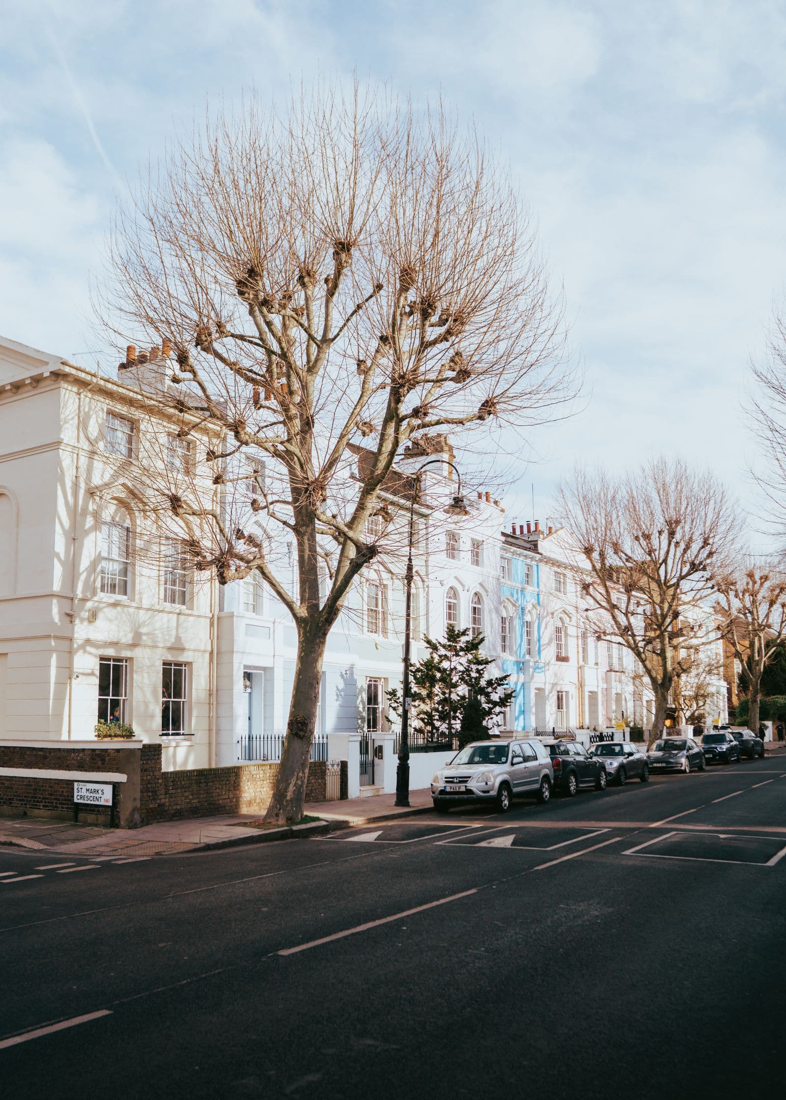Urban street with leafless trees and period buildings