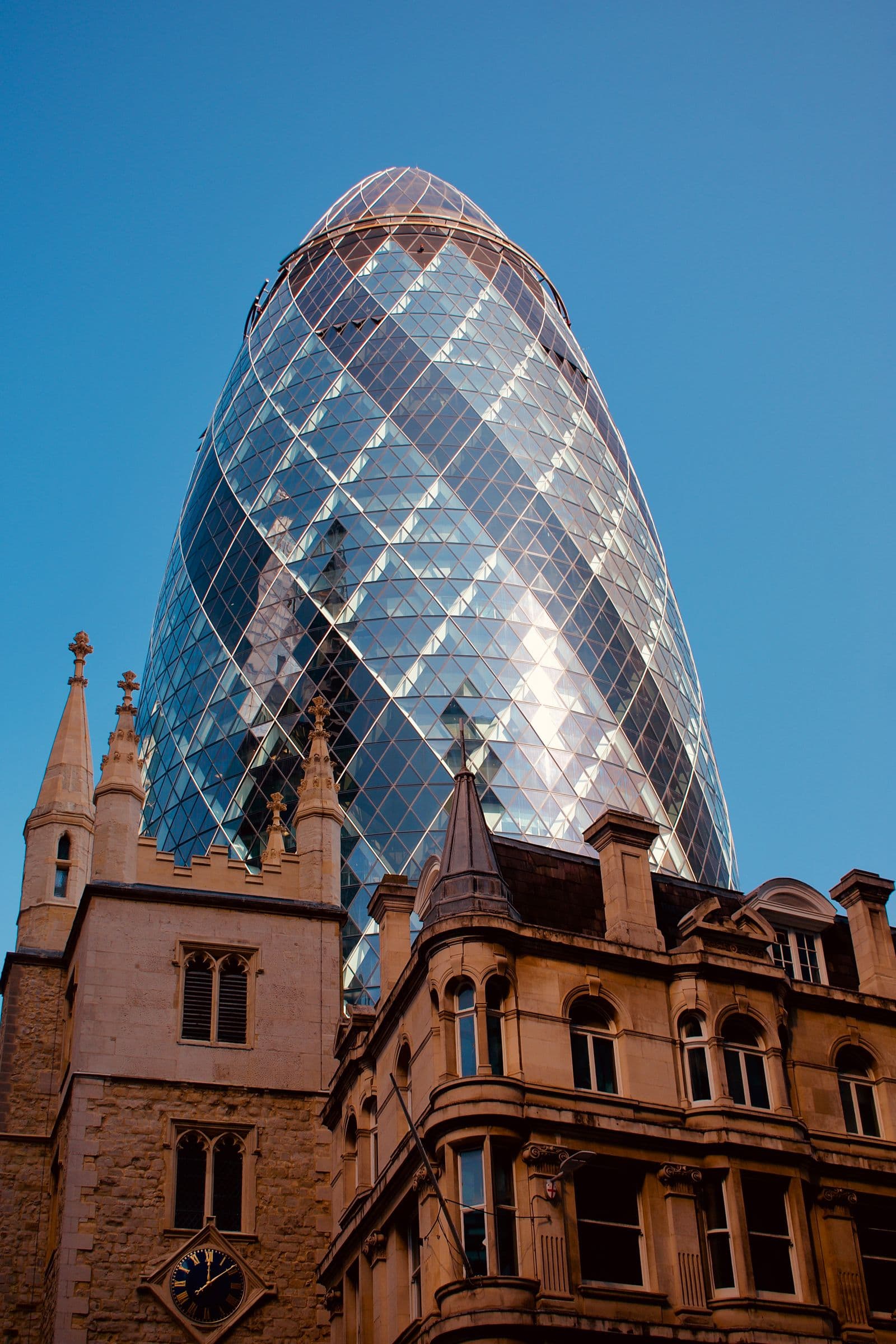 Glass skyscraper rising behind a red brick Victorian building