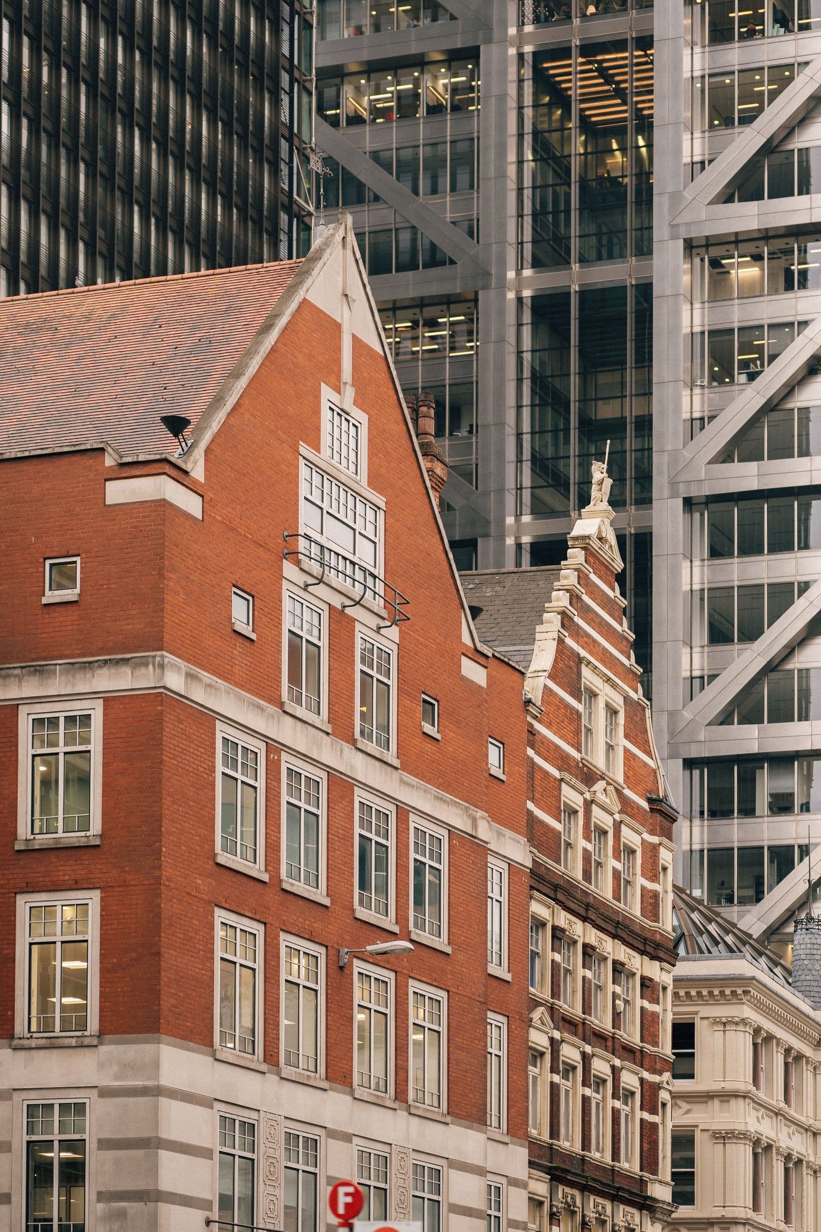 Red brick buildings beside modern architecture