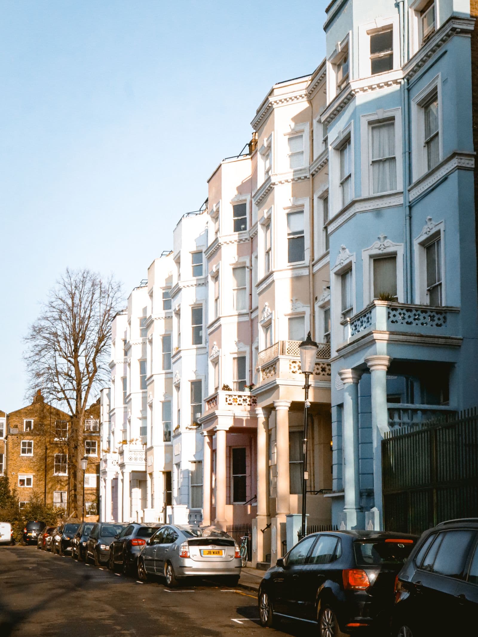 Row of pastel-coloured terraced houses
