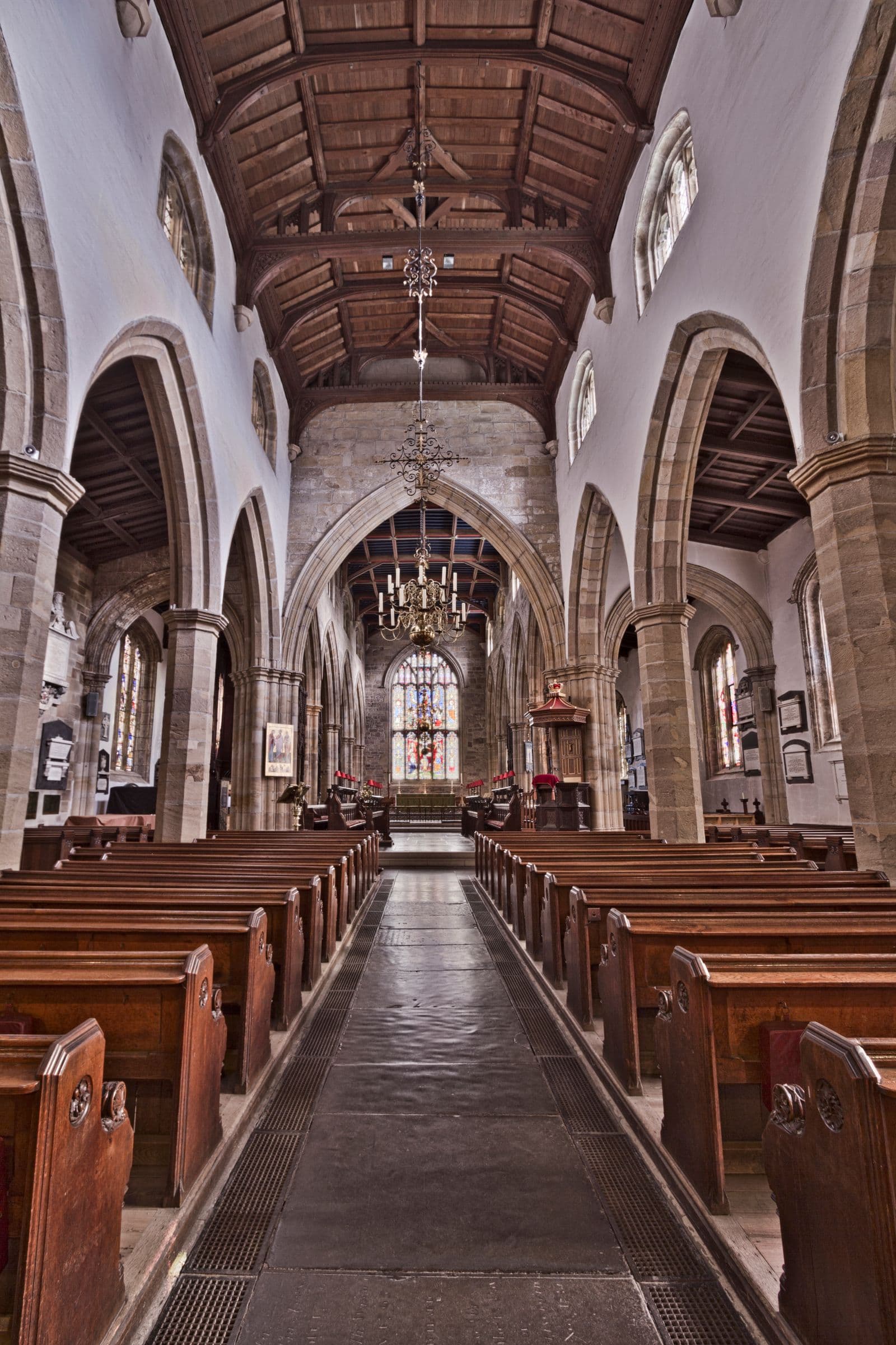 Stone arches and pews inside a gothic church