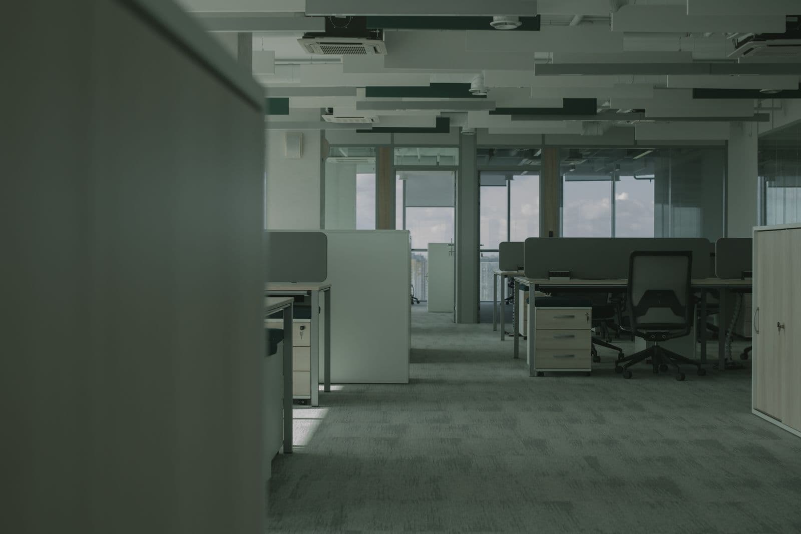 Open-plan office with rows of desks and chairs