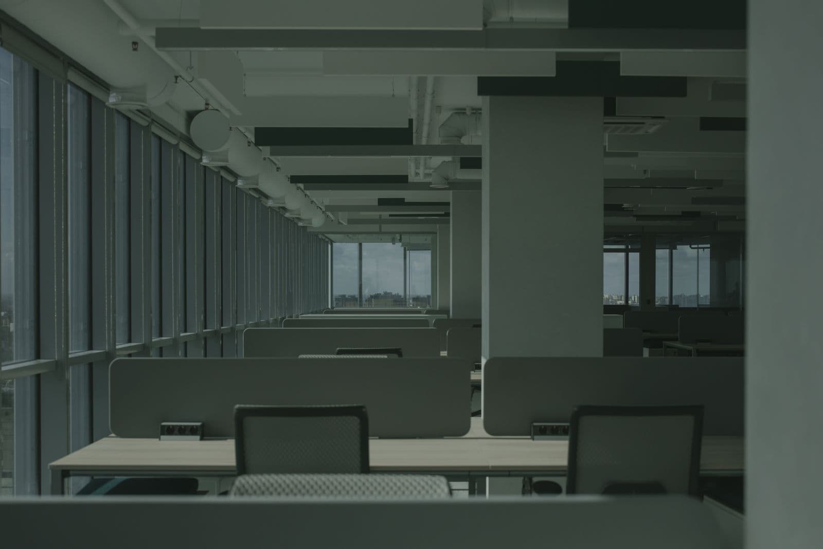 Rows of empty desks in an open-plan office
