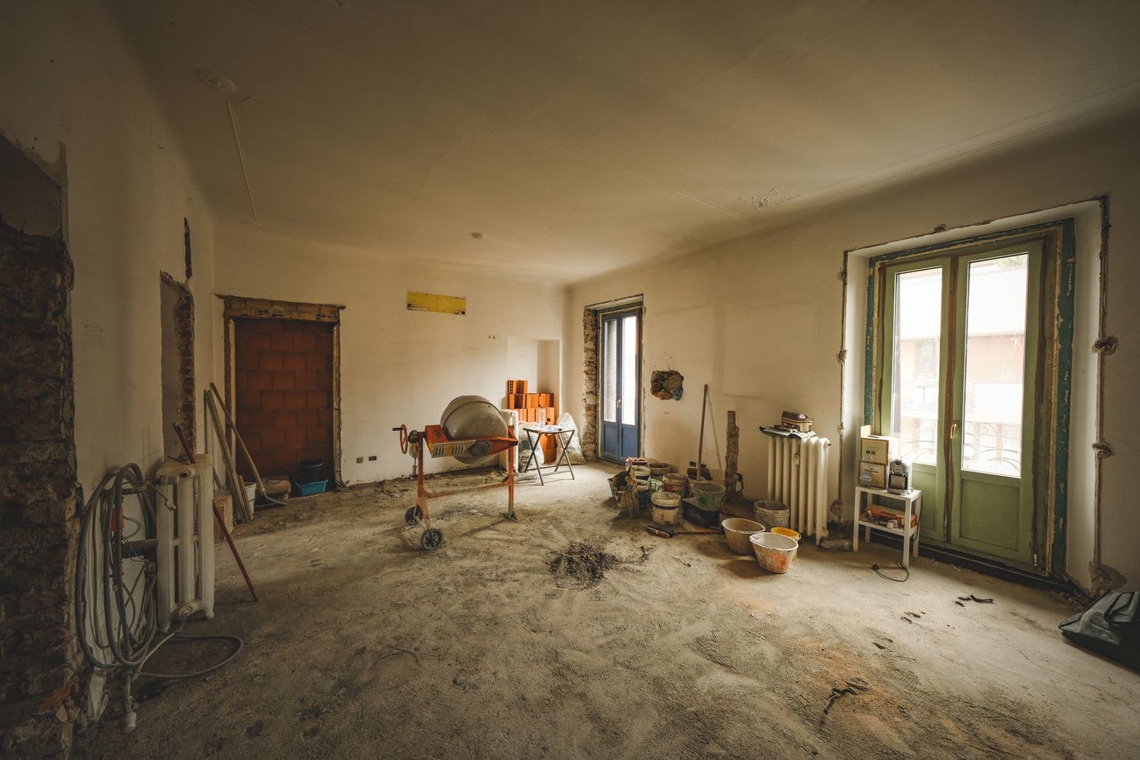Sunlit room after renovation work with dust and building materials