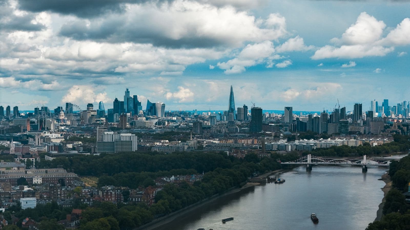 Wide view of a city skyline over the River Thames
